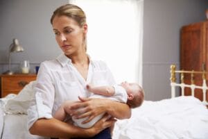 Woman suffering with postnatal depression