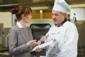 Chef and inspector talking about food hygiene