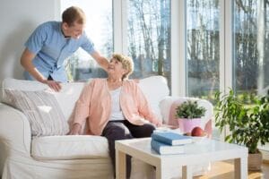 Male nurse helping patient living with dementia