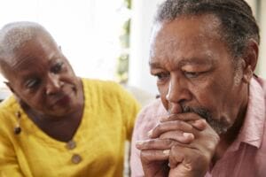 Man living with dementia being supported by his wife
