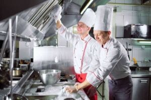 Chefs cleaning as you go after busy day