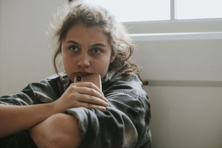 Teenage girl struggling with OCD sat at home alone