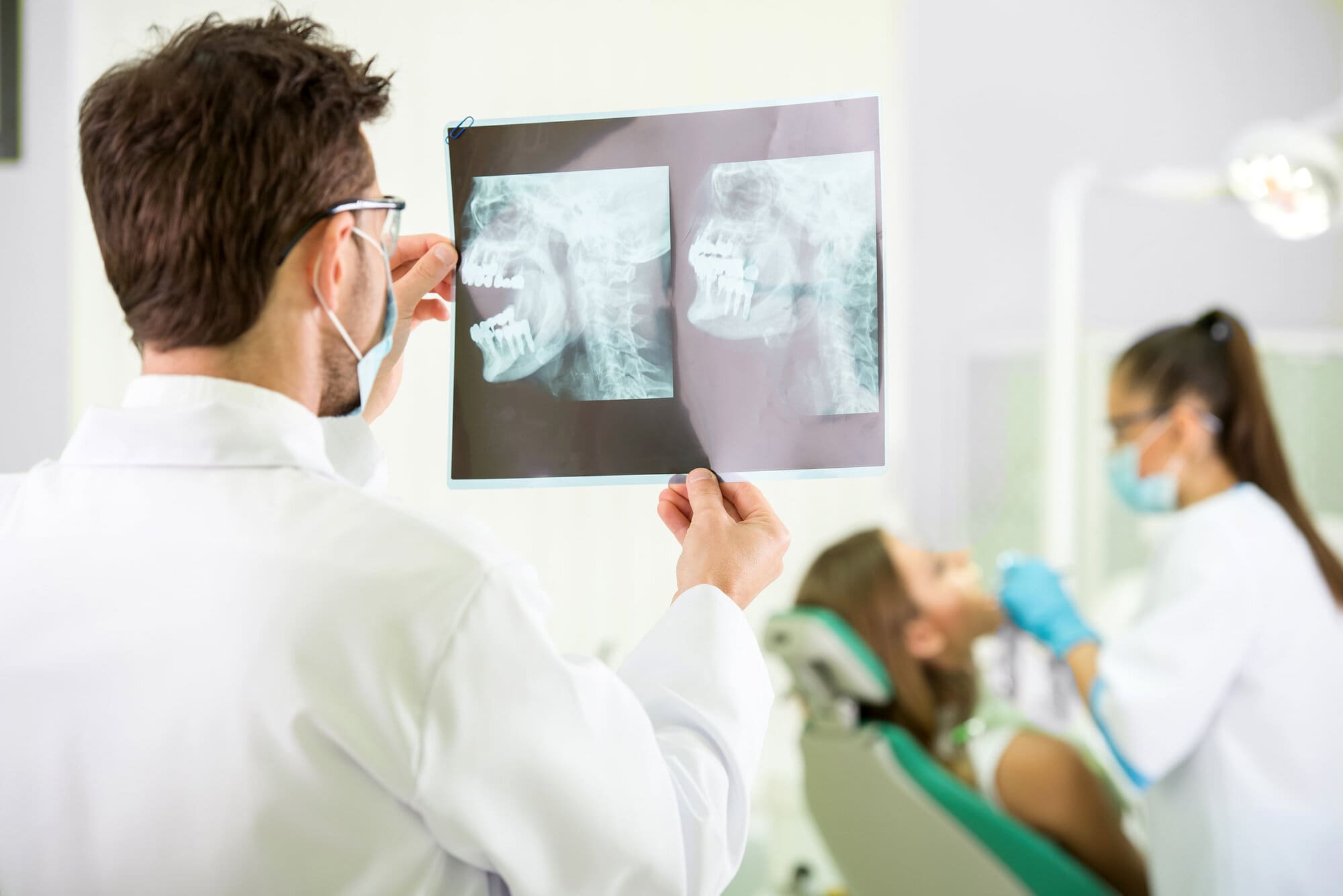 Dentist examining x-rays