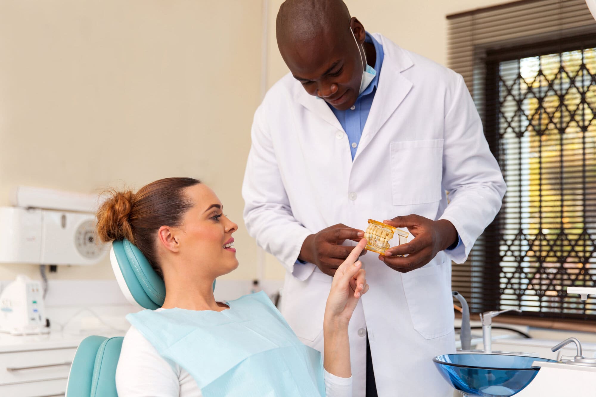Dentist having consultation treatment with client