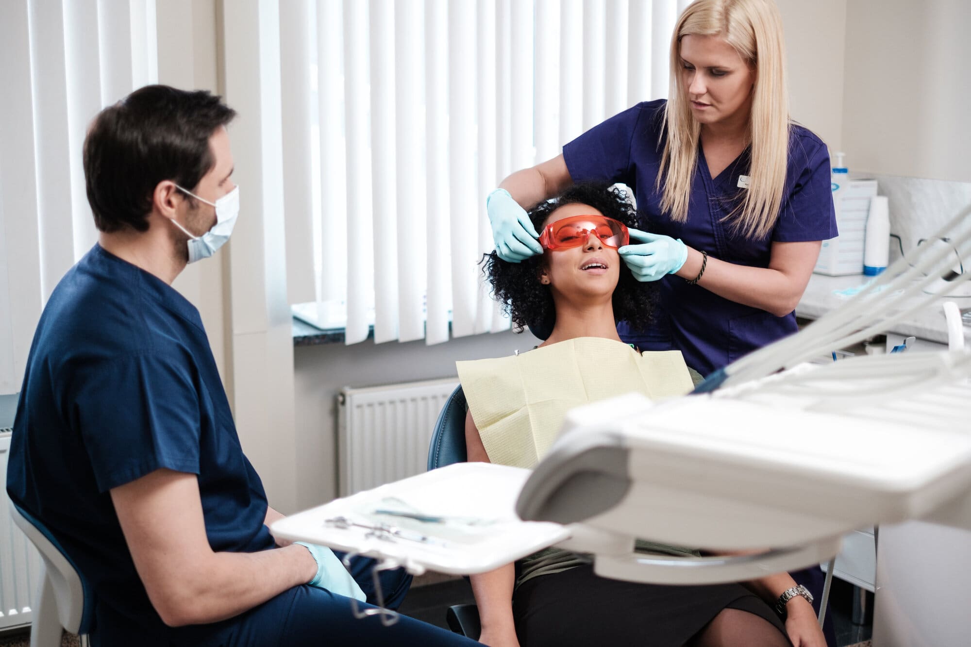 Dentist and dental nurse working in surgery