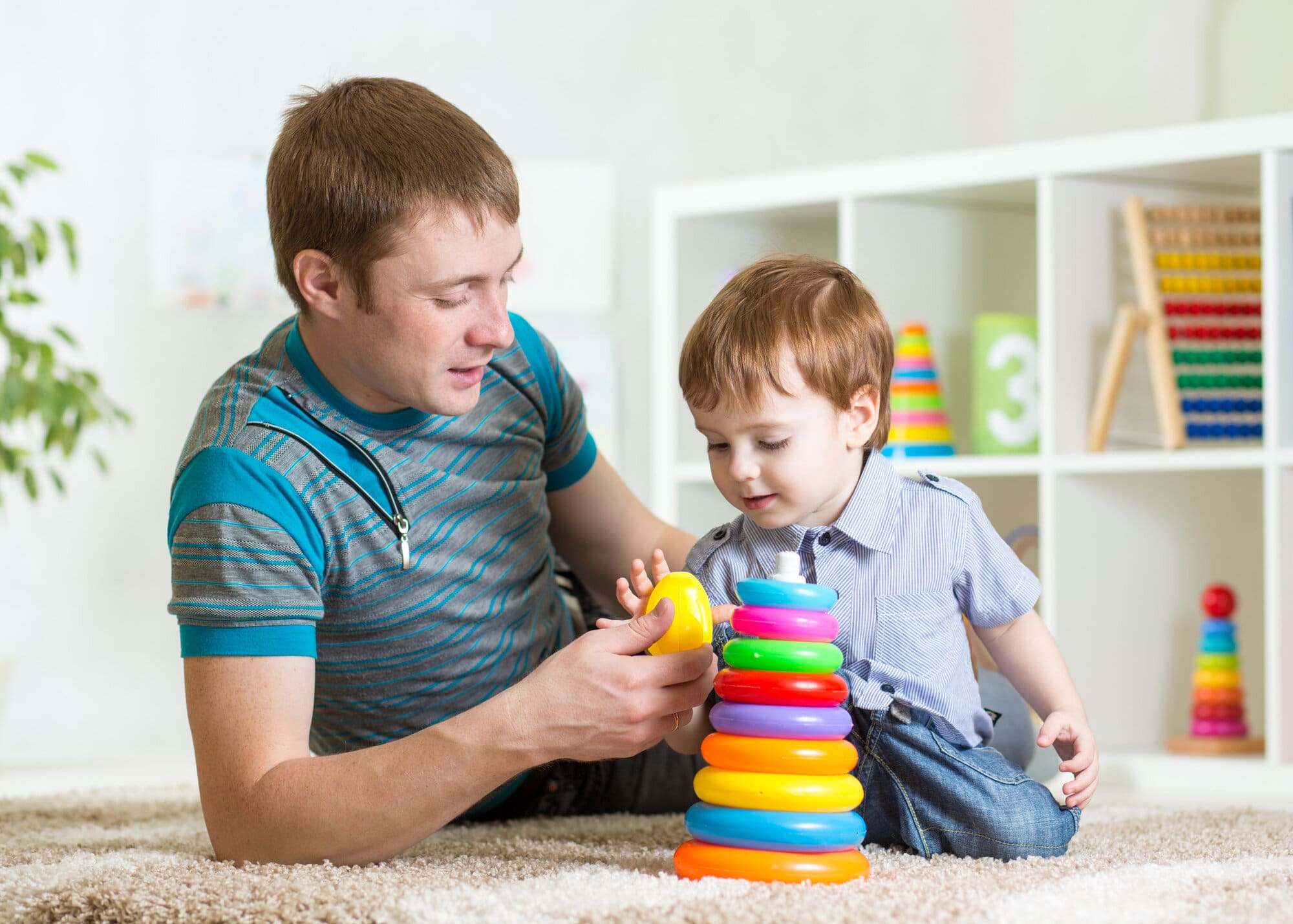 Man playing with young child