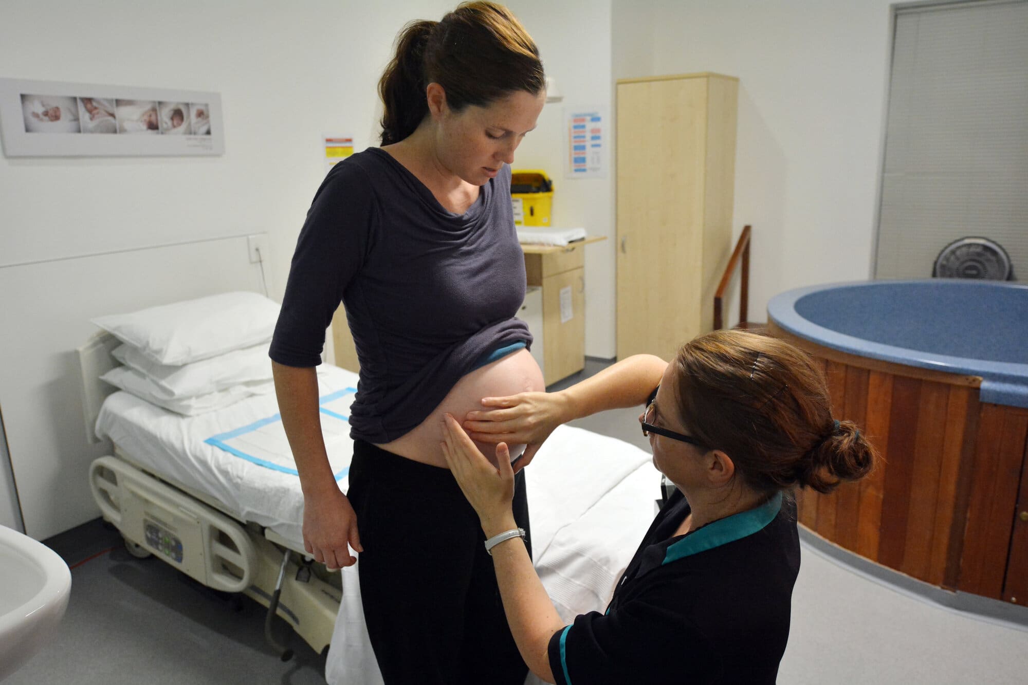 Midwife volunteering on labour ward with delivery of baby