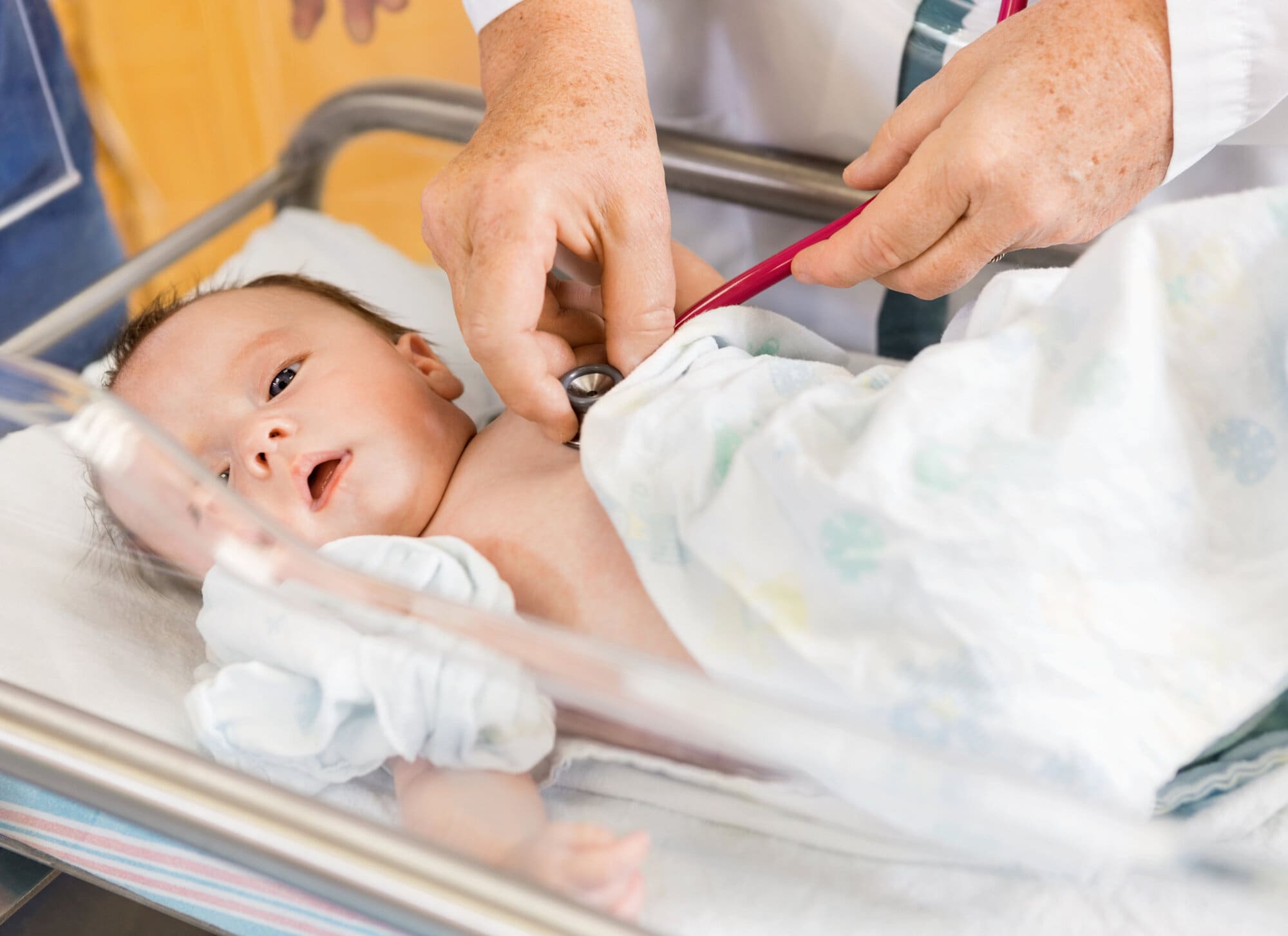 Midwife examining new born baby