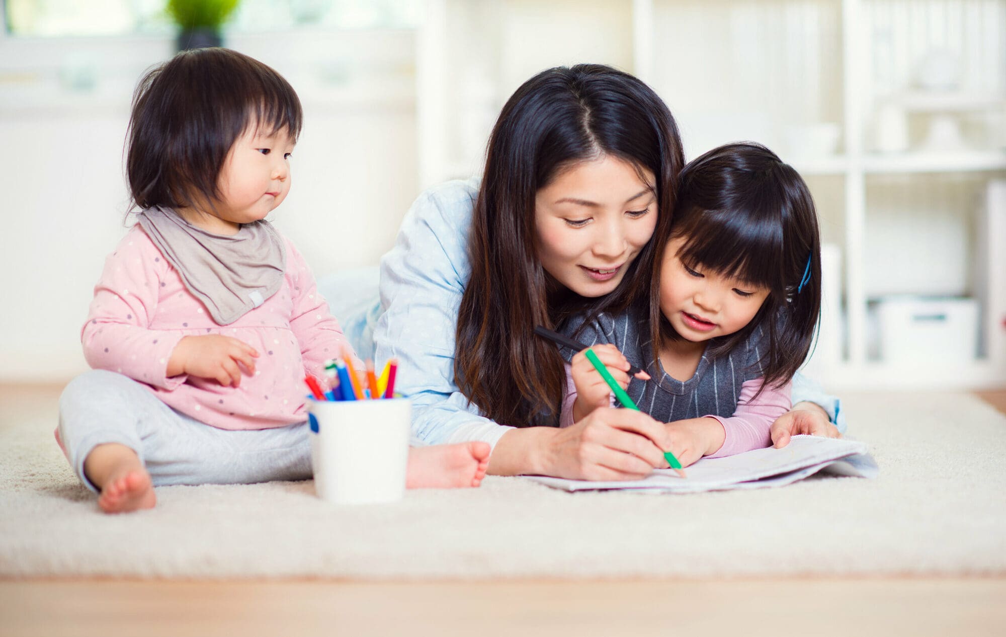 A mother helping her children learn new skills