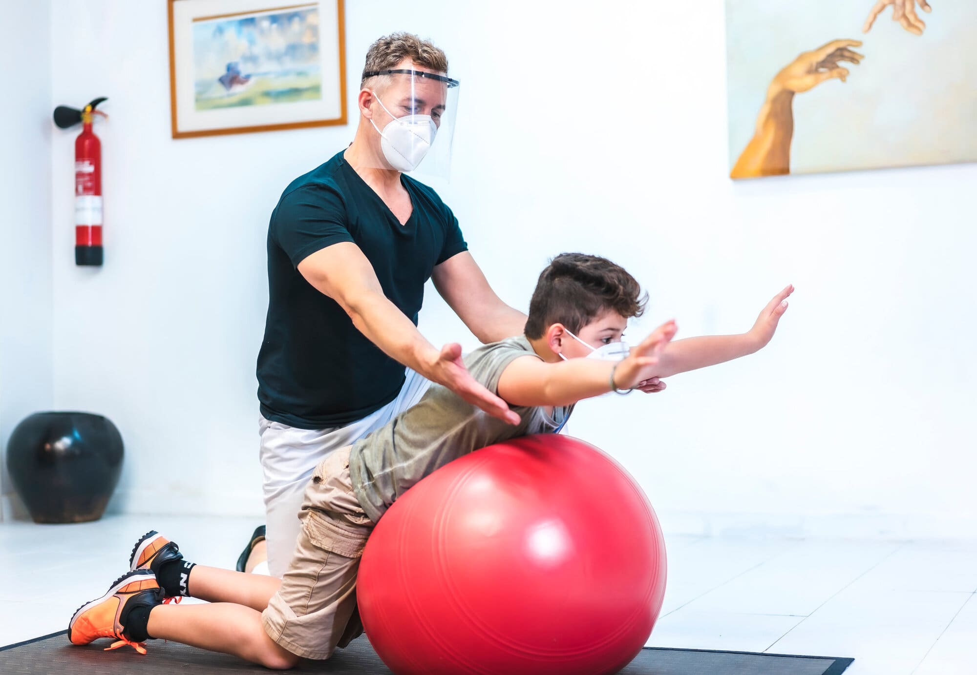 Physiotherapist working in school with young child