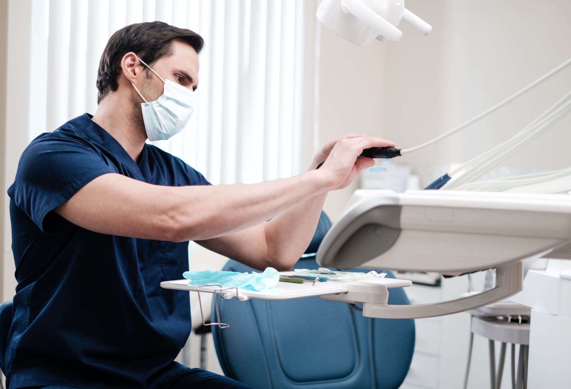 Dentist setting up station ready for next patient