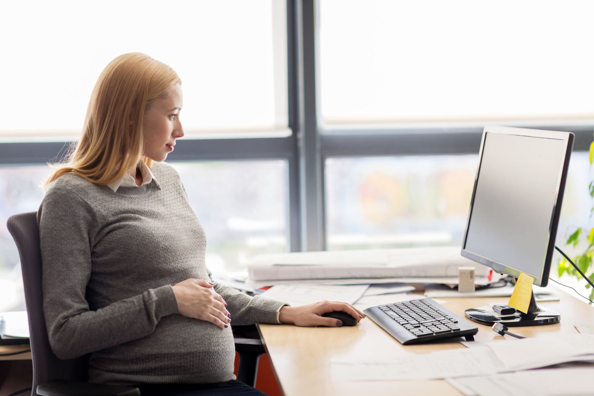 Social worker carrying out her responsibilities writing up reports