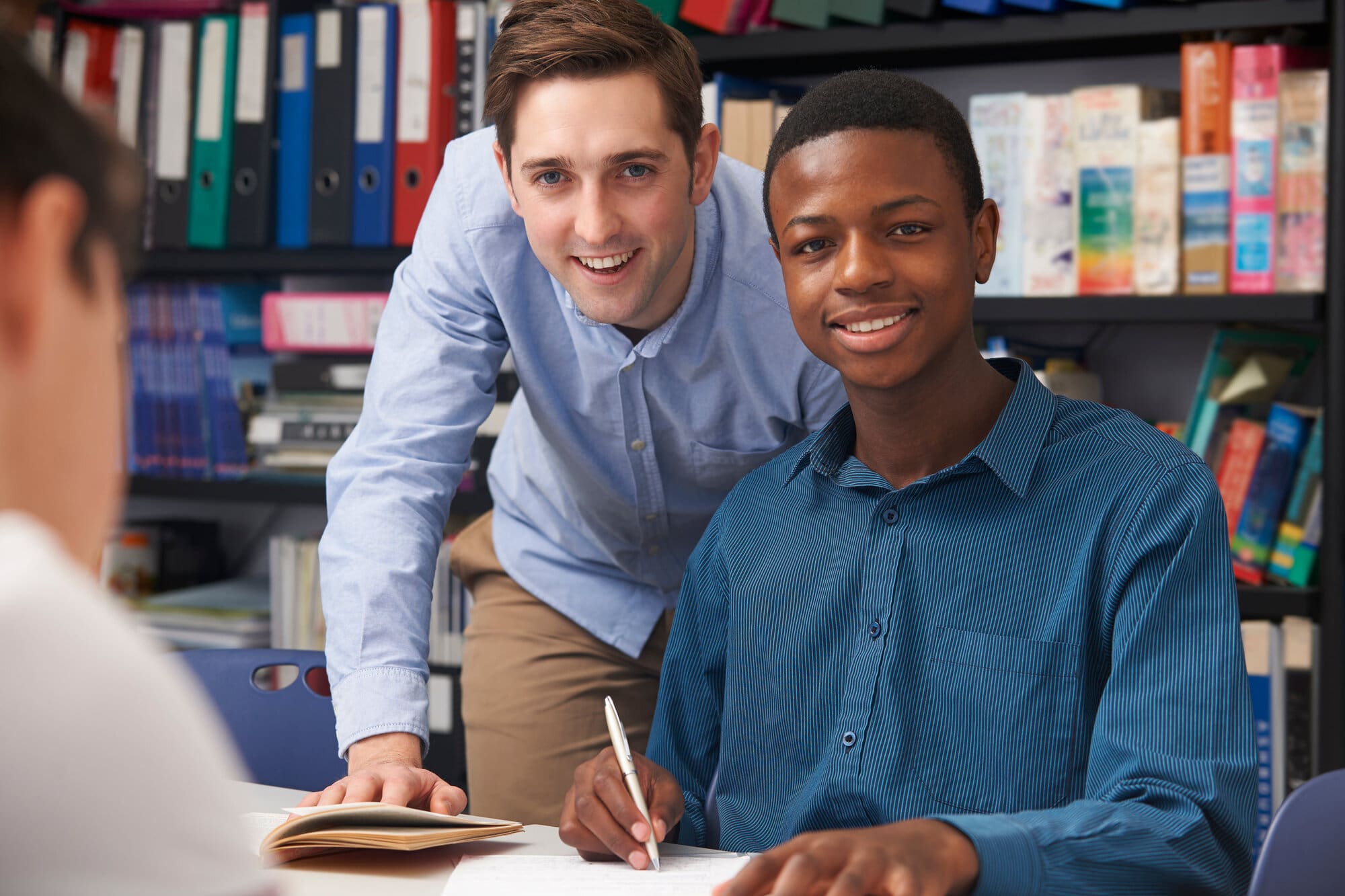 Tutor with lots of qualifications helping male student