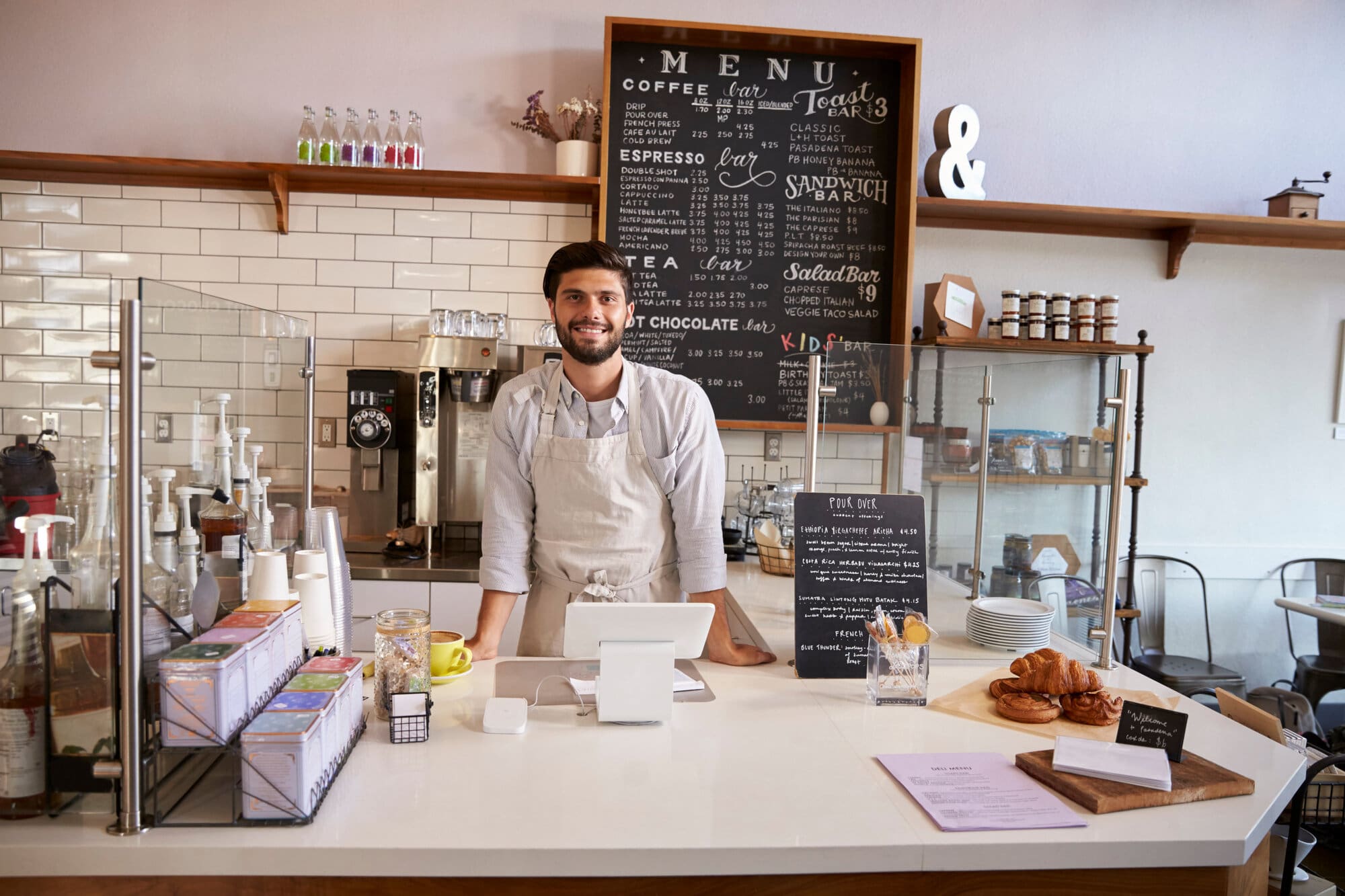 Coffee shop worker at till