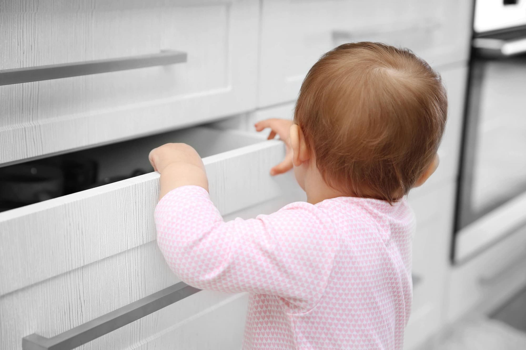 Child playing with drawer
