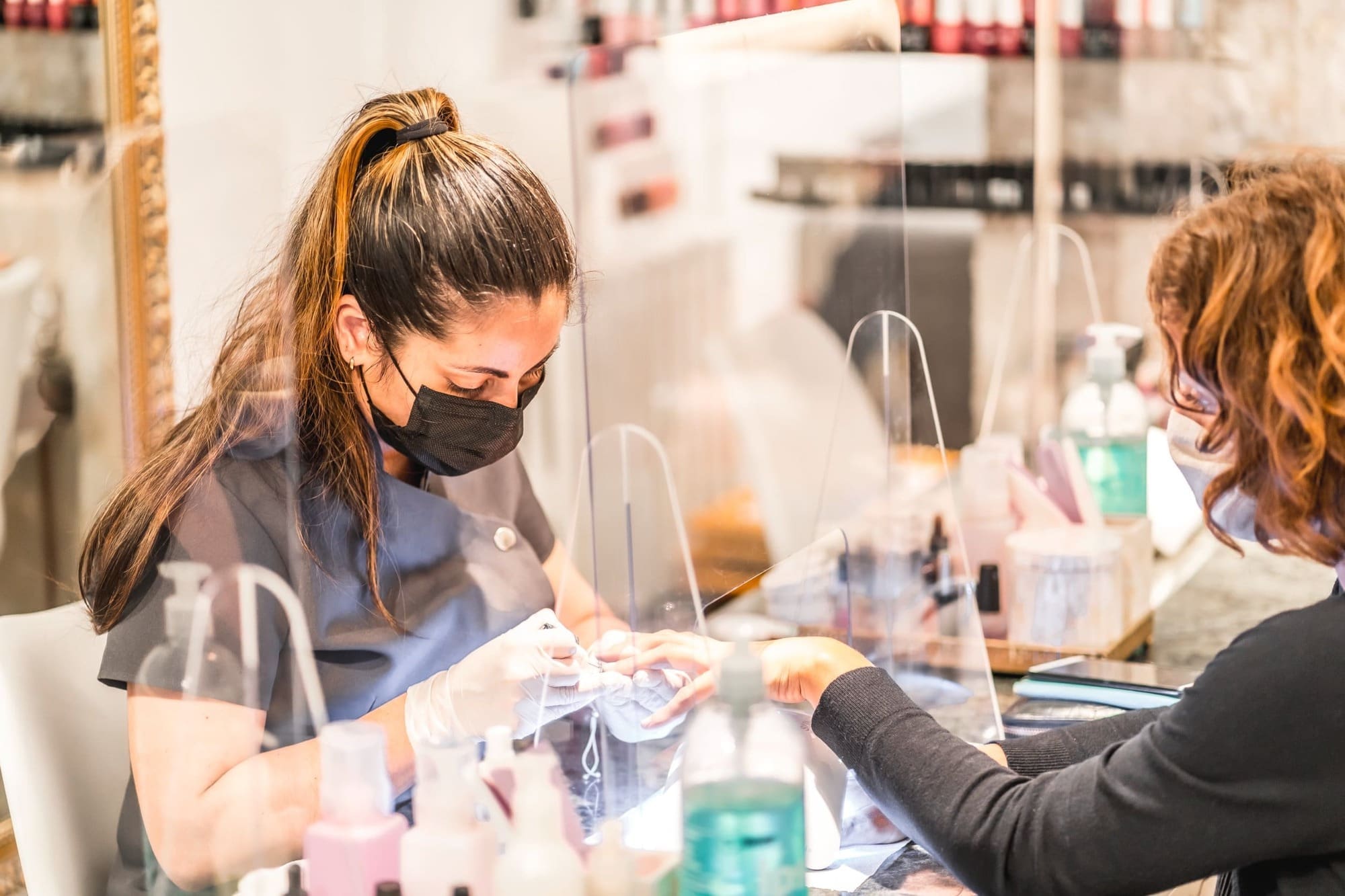 Nail artist wearing mask for safety