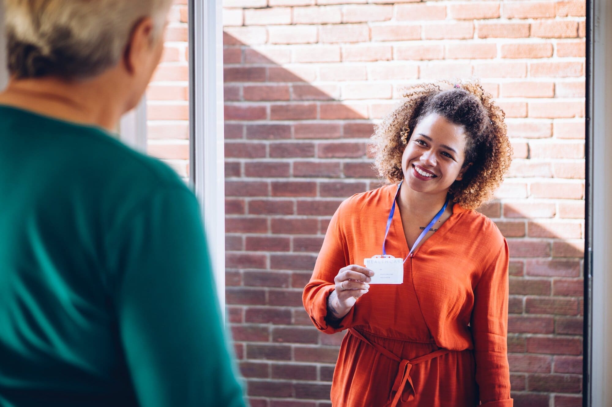 Domiciliary care worker visiting home