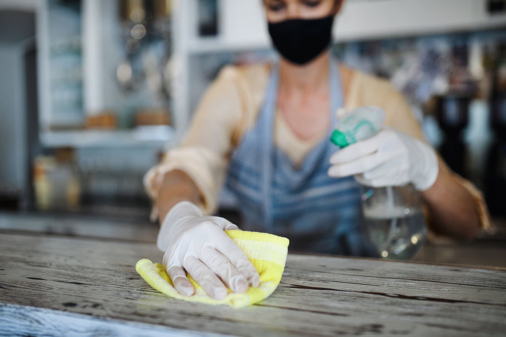 Coffee shop owner cleaning surfaces