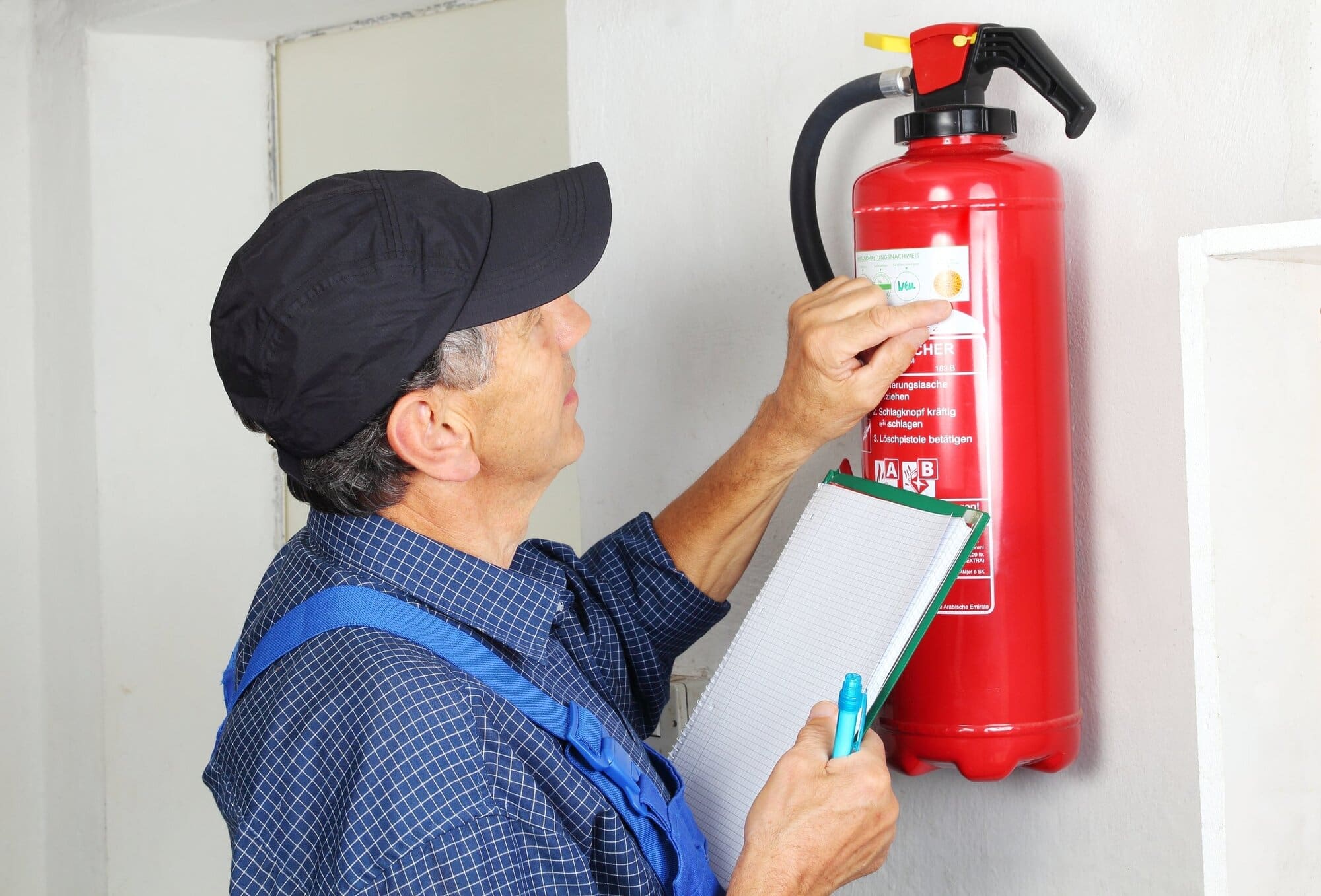 Firefighter checking fire safety equipment