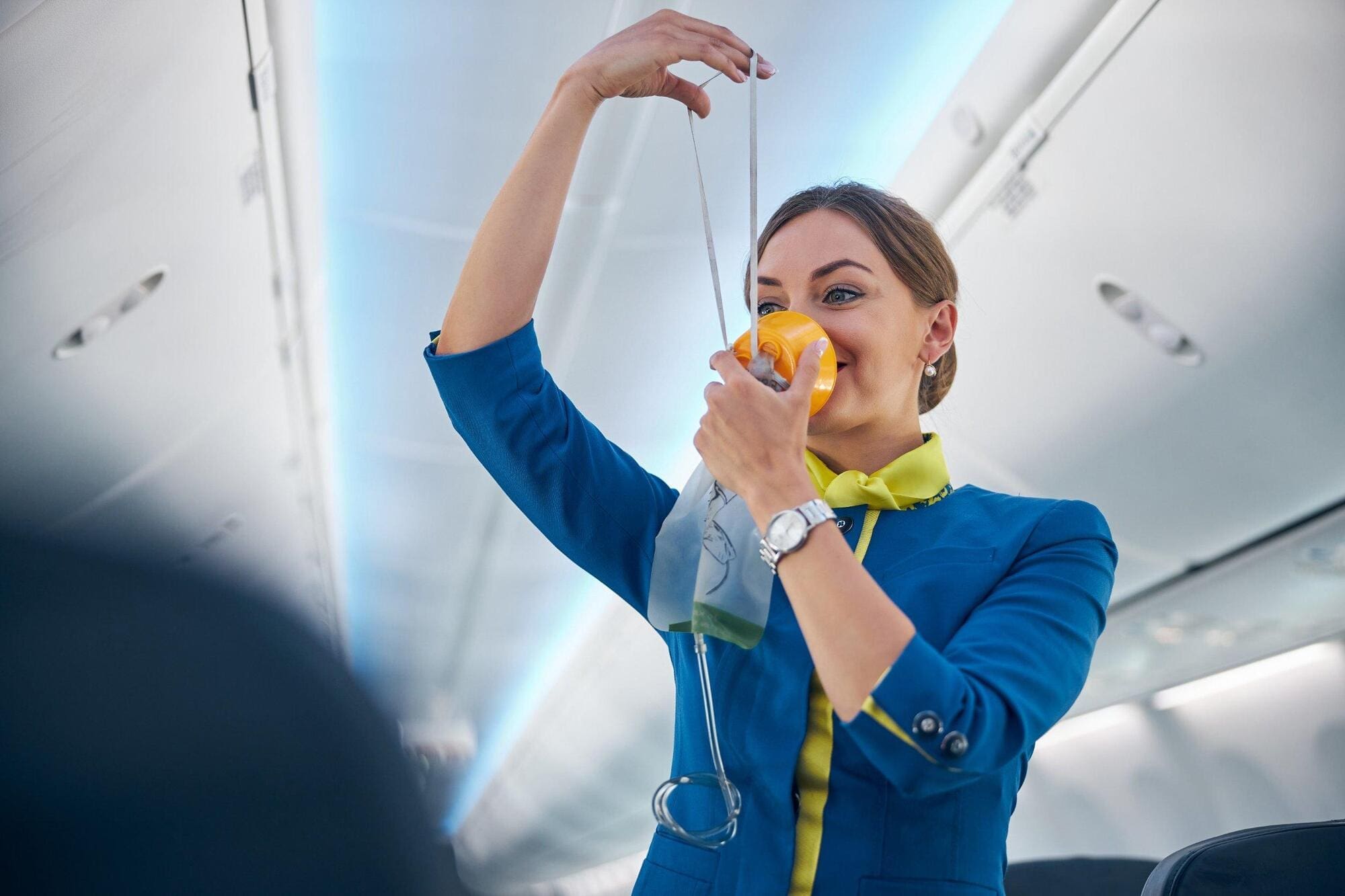 Flight attendant demonstrating safety