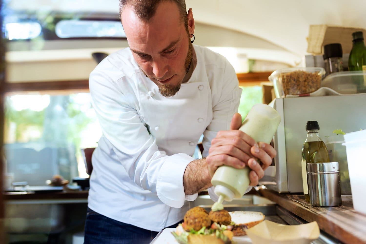 Man making food for his catering business in his catering van