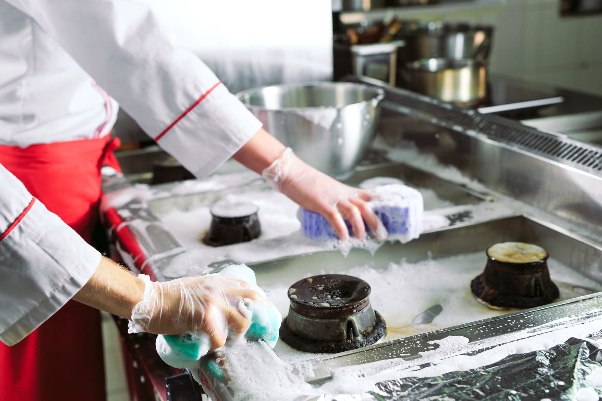 Nursery staff cleaning kitchen after making lunches