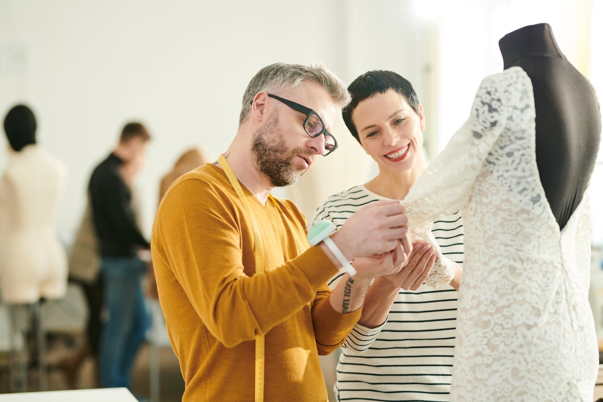 Wedding fashion designer meeting with his customer