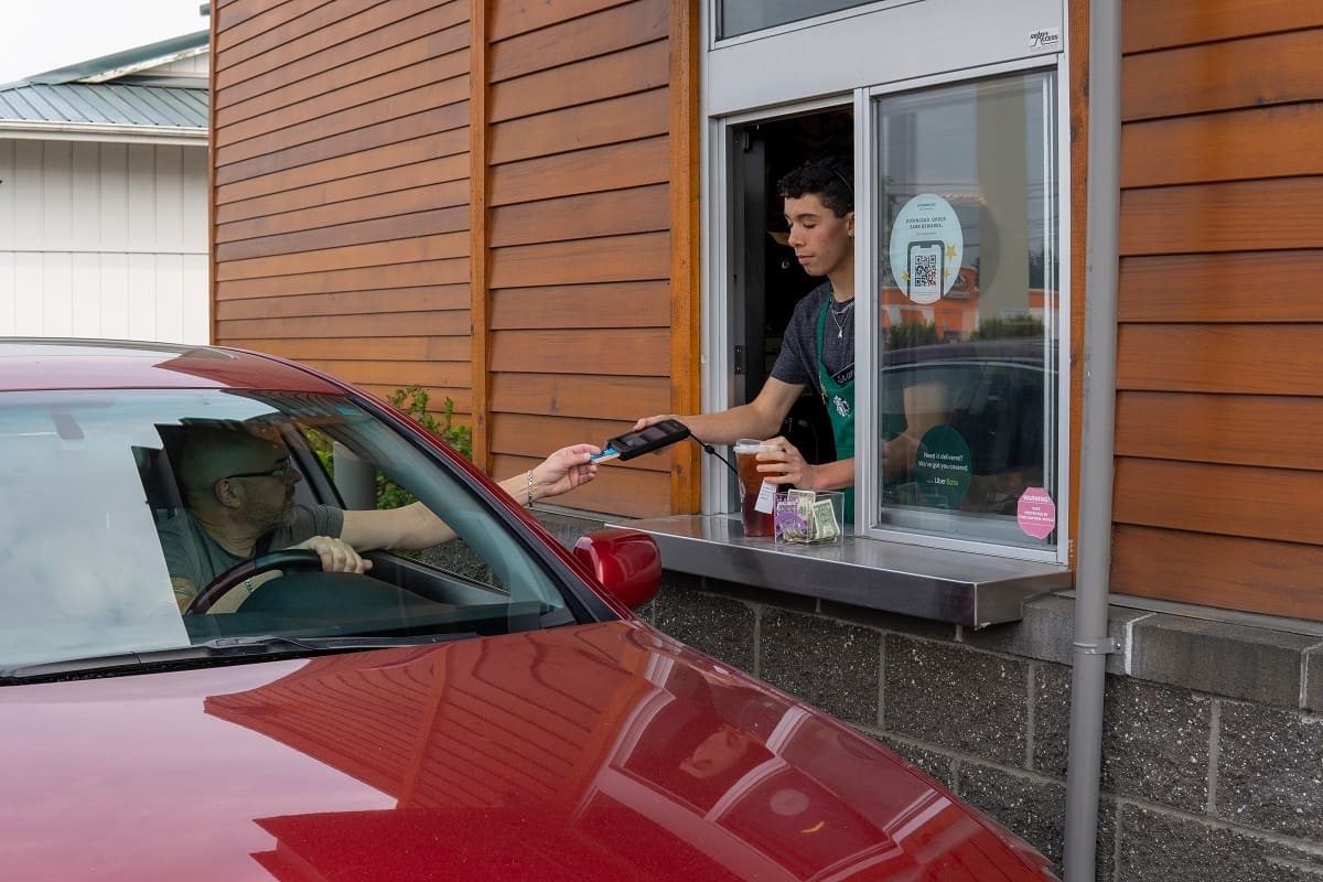 Barista working in drive thru.