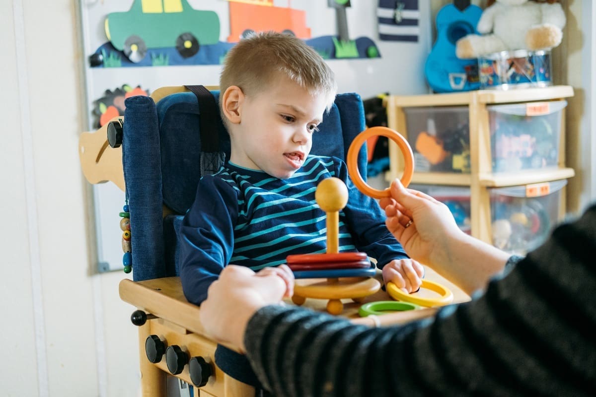 Child with learning difficulties being cared for