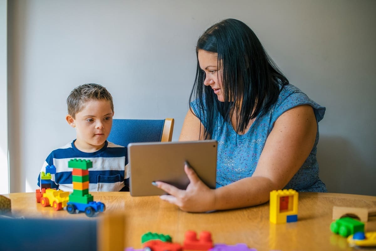 Woman working with child who needs additional support