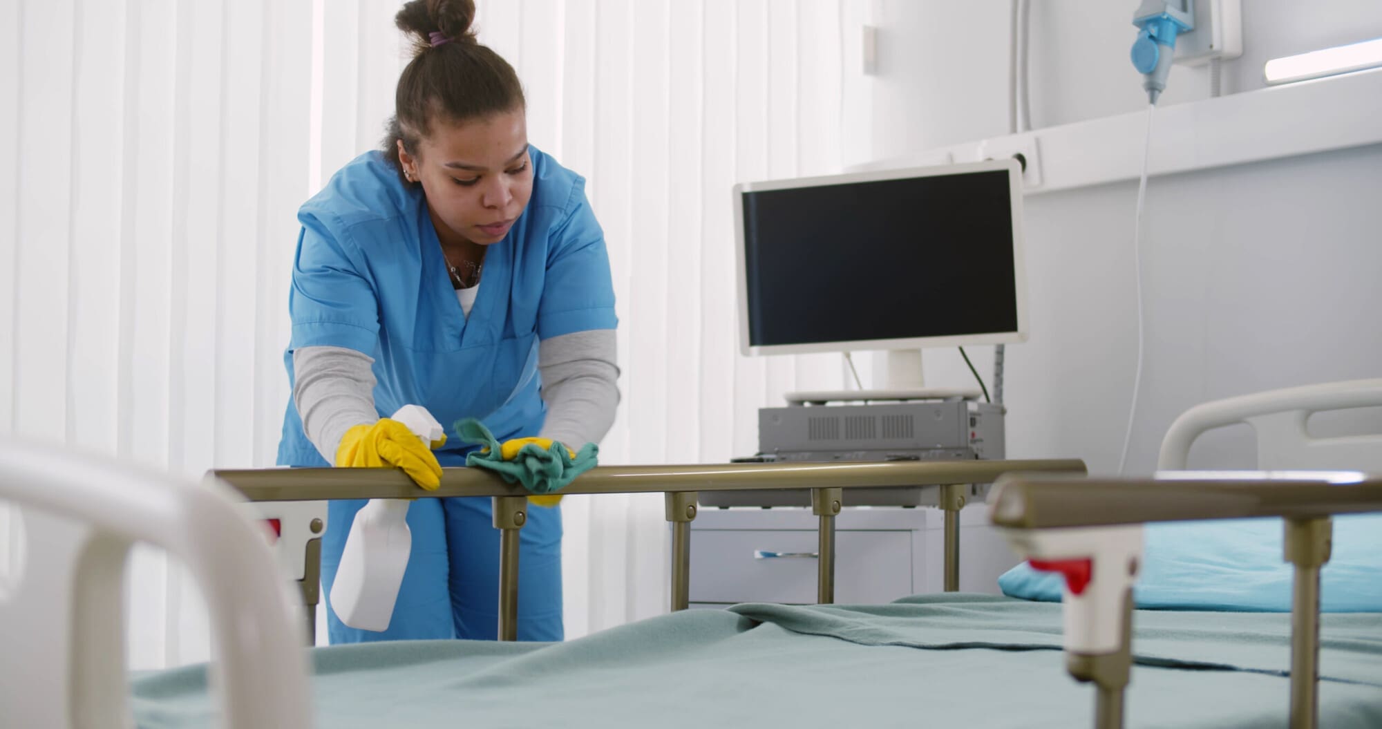 Housekeeper Cleaning Hospital Bed
