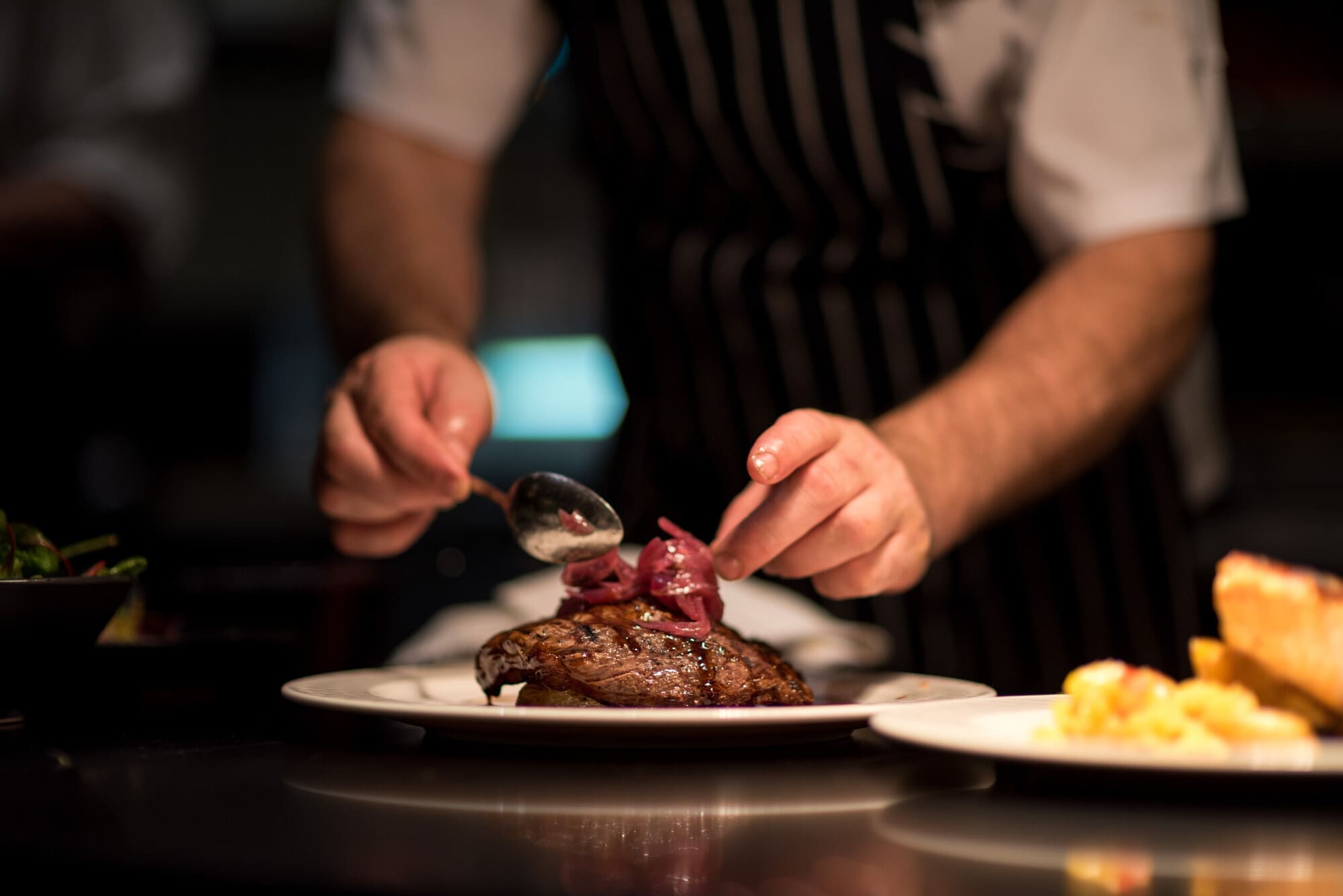 Personal Chef Finishing Off A Plate Of Food