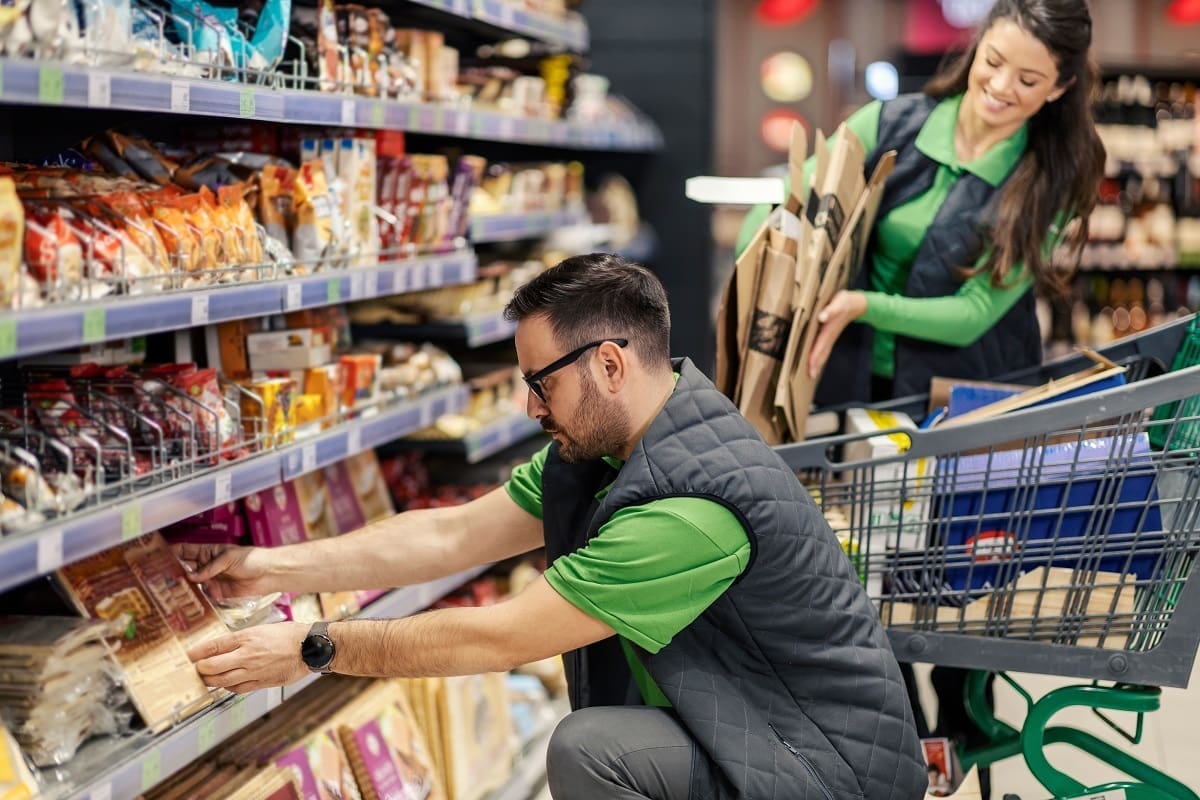 Supermarket workers ensuring food is stored safely